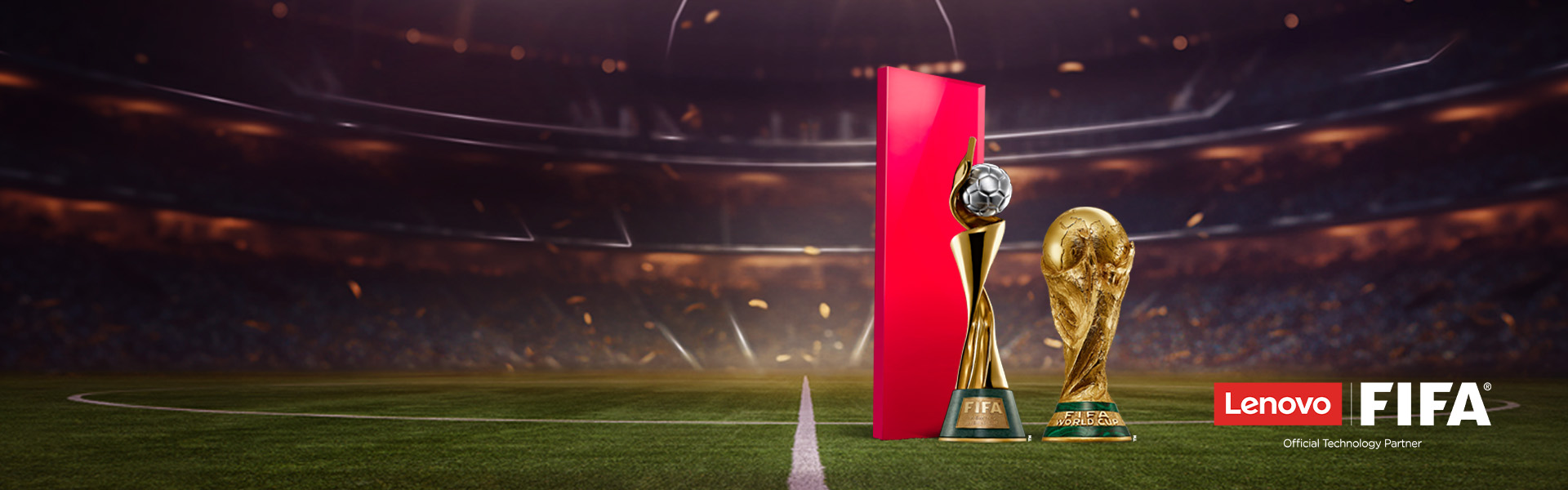 Soccer field with blurred stadium crowd, FIFA World Cup trophy, red structure with soccer ball on top, Lenovo and FIFA logos, and 